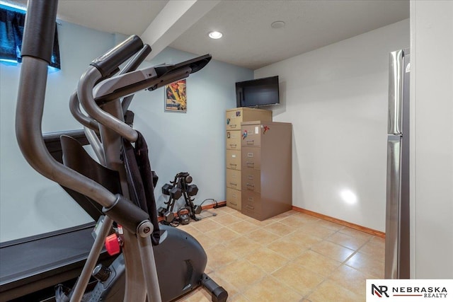 exercise room with recessed lighting and baseboards