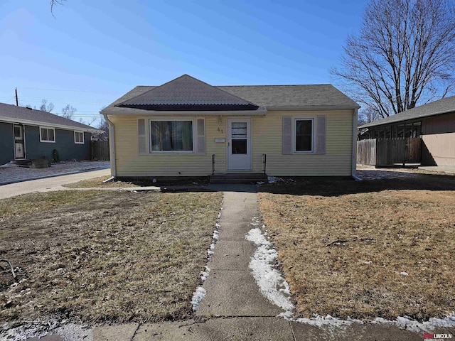 bungalow-style home featuring fence