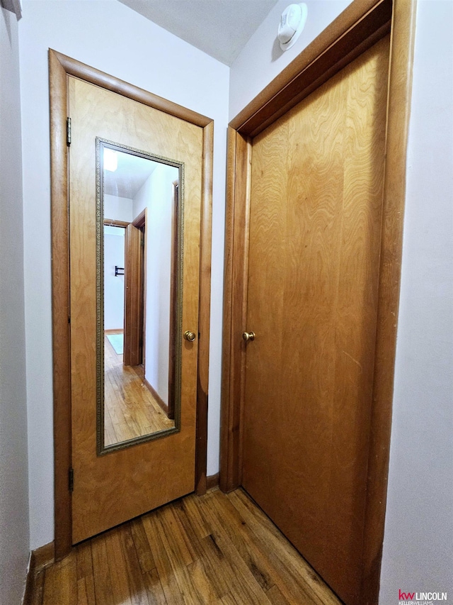 corridor with wood finished floors