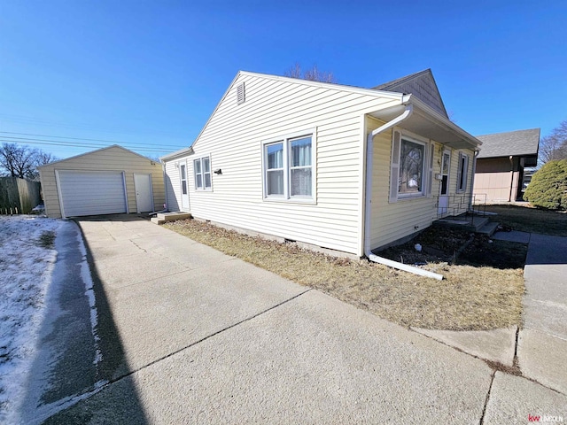 view of property exterior with a detached garage, concrete driveway, an outdoor structure, and crawl space