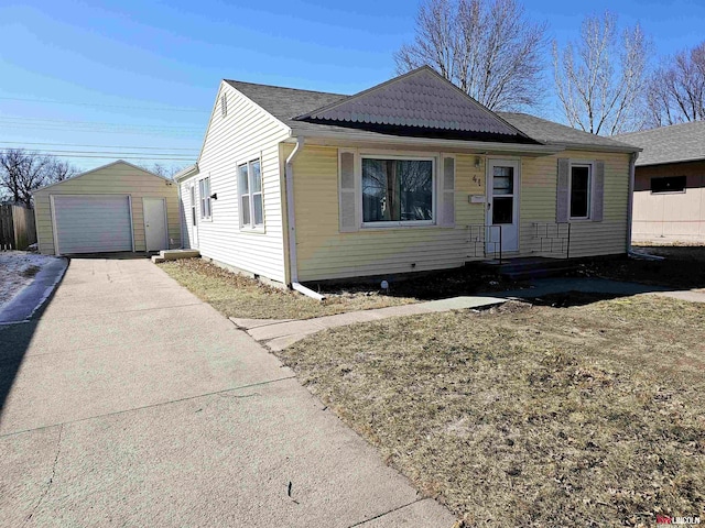 bungalow-style home with an outdoor structure, concrete driveway, a garage, and crawl space