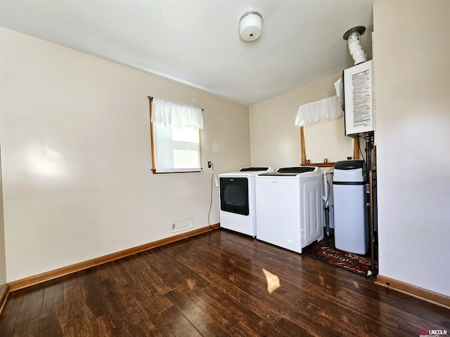 laundry room with laundry area, dark wood-style flooring, baseboards, and separate washer and dryer