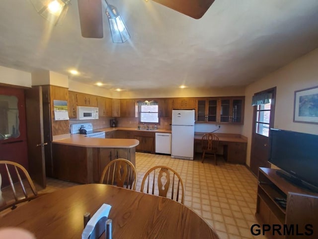 dining room with light floors and a ceiling fan