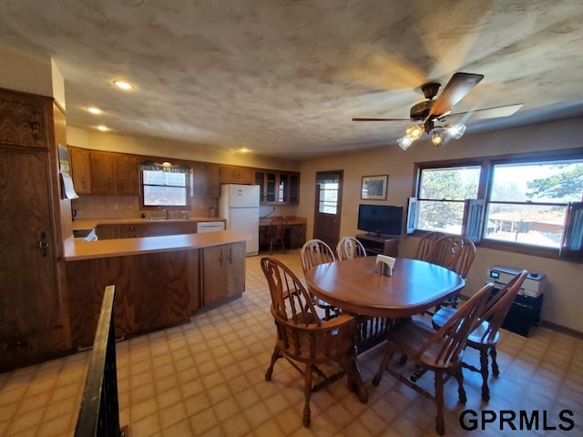 dining area with a ceiling fan, plenty of natural light, light floors, and recessed lighting