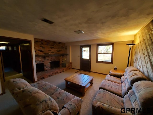 carpeted living room featuring a brick fireplace and visible vents