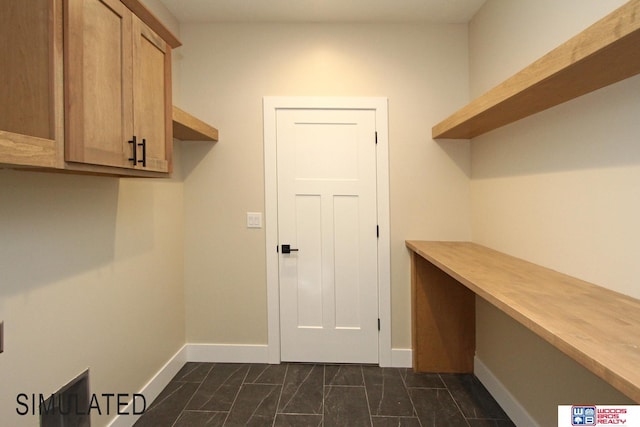 clothes washing area featuring baseboards