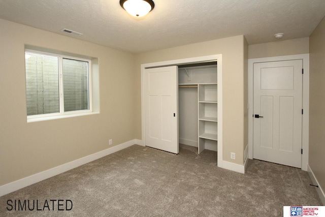 unfurnished bedroom featuring a closet, visible vents, baseboards, and carpet