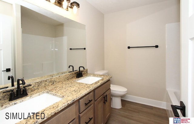 full bathroom with toilet, wood finished floors, baseboards, and a sink