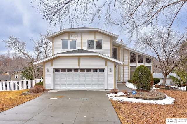 view of front facade with a garage, a chimney, driveway, and fence