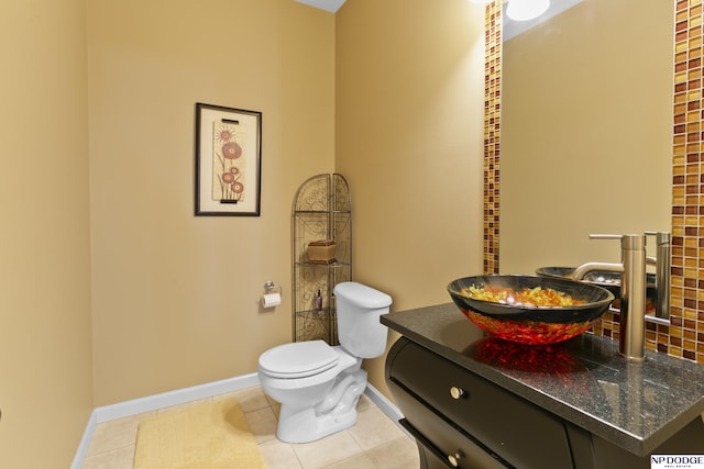 bathroom featuring vanity, tile patterned floors, toilet, and baseboards