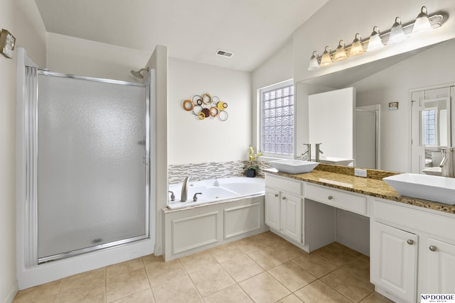 bathroom featuring tile patterned flooring, visible vents, a shower stall, and a sink