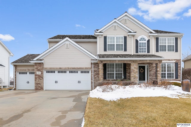 traditional home featuring brick siding, an attached garage, and concrete driveway