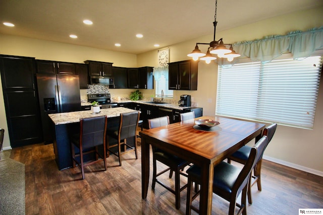 dining space with recessed lighting, baseboards, and dark wood-style flooring