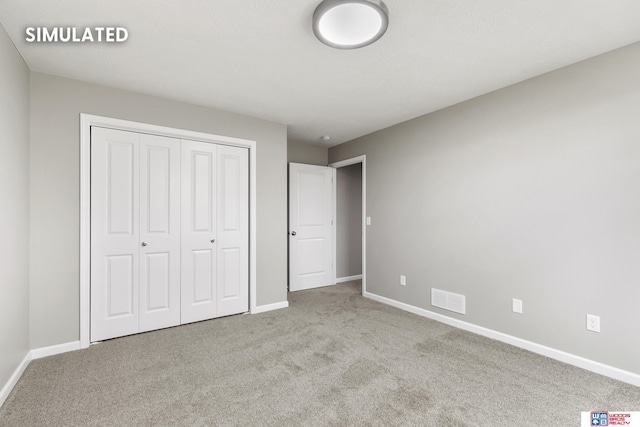 unfurnished bedroom featuring a closet, visible vents, carpet flooring, and baseboards