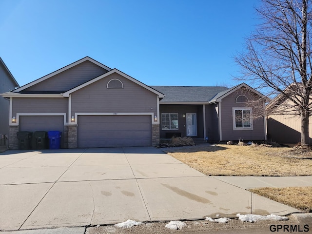 ranch-style home with an attached garage and driveway