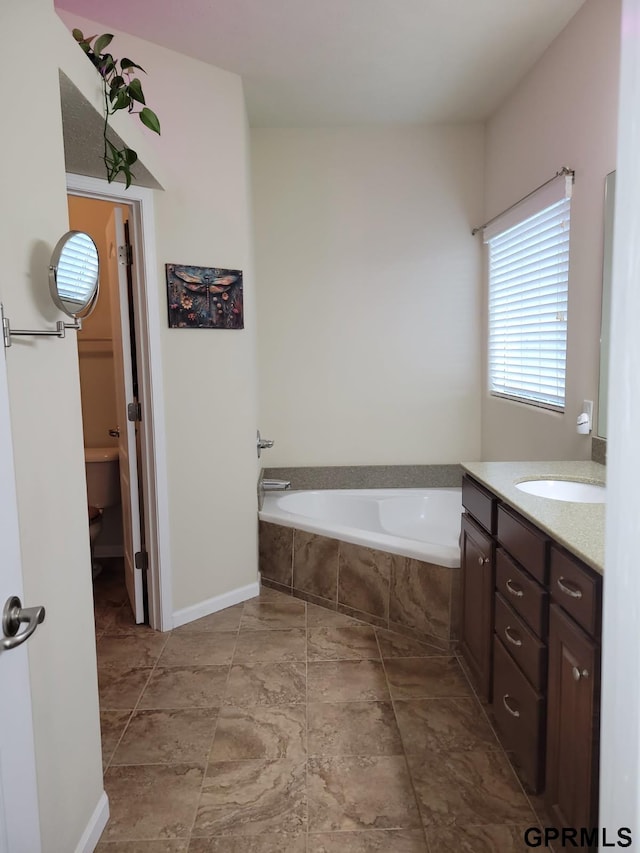 full bathroom featuring vanity and a garden tub