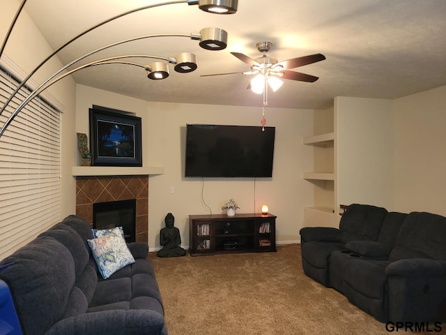 living room with a fireplace, carpet floors, and ceiling fan