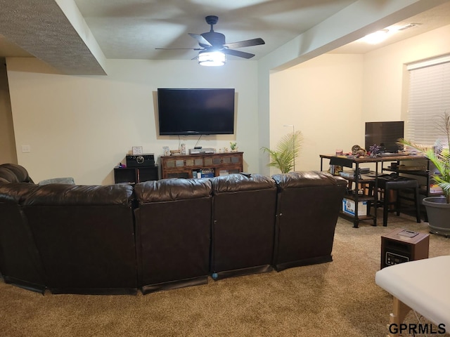 living area with light carpet and ceiling fan