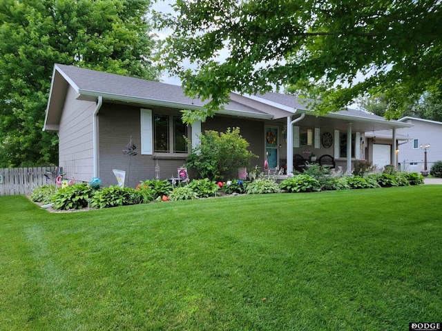 ranch-style house featuring a garage, brick siding, a front yard, and fence