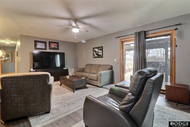 living area with a ceiling fan and wood finished floors