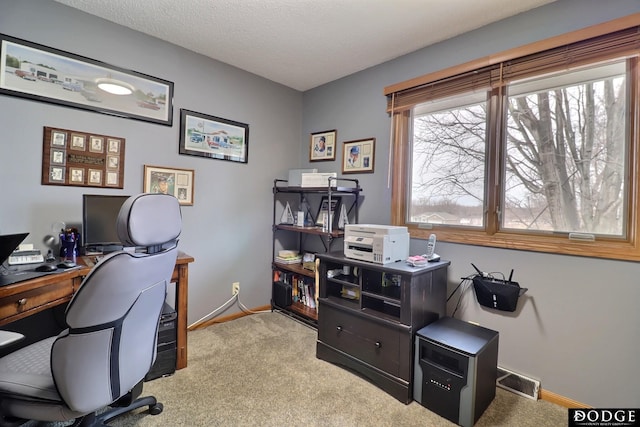 home office with visible vents, baseboards, carpet, and a textured ceiling