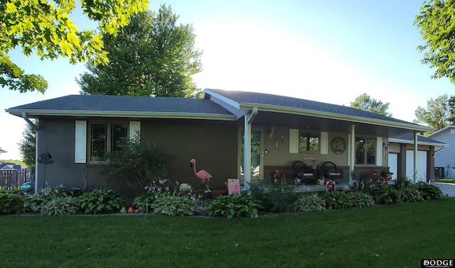 single story home with a front lawn, a porch, brick siding, and a garage