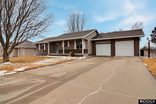 ranch-style home with stucco siding, a garage, and concrete driveway