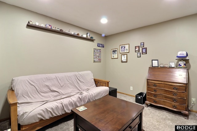 living area with baseboards and light colored carpet