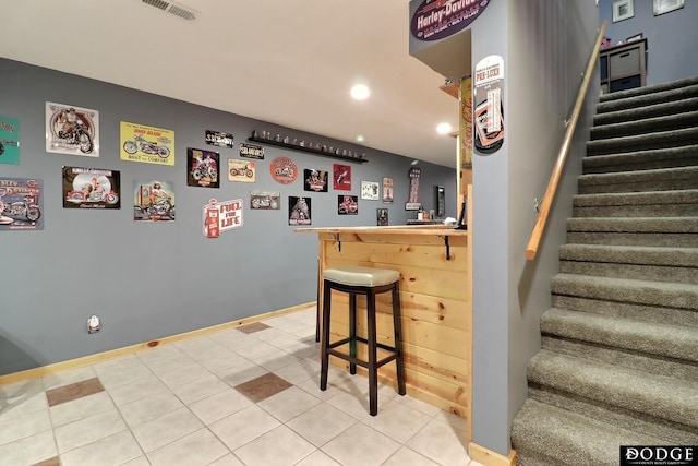 bar with visible vents, baseboards, recessed lighting, stairs, and a bar