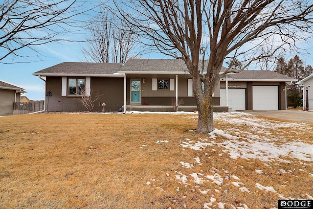 single story home with fence, stucco siding, a front lawn, concrete driveway, and a garage