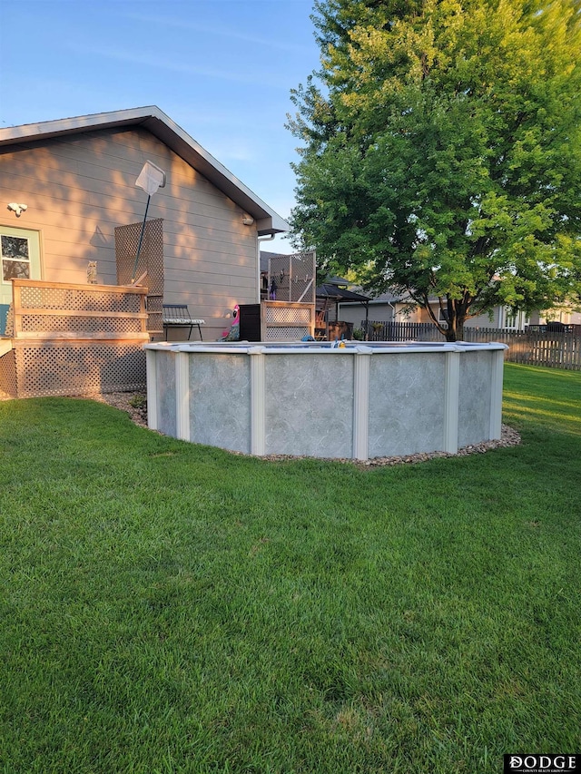 exterior space with a fenced in pool, a wooden deck, and fence