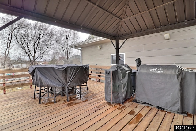 deck featuring a gazebo, area for grilling, and outdoor dining area