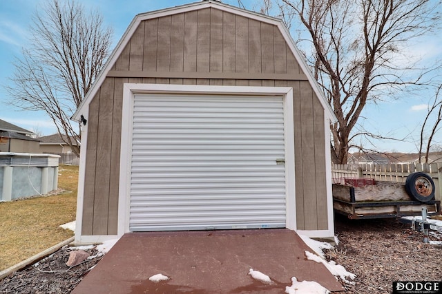 garage with a shed and fence