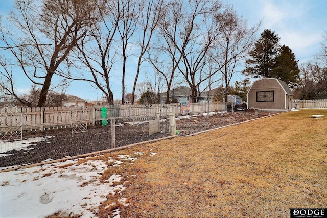 view of yard with an outbuilding, a storage unit, and a fenced backyard