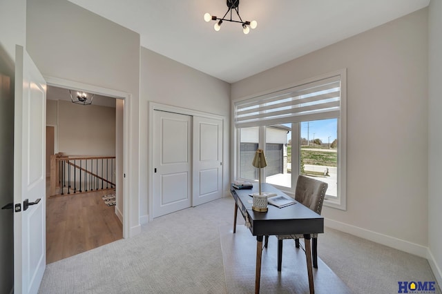 home office with a notable chandelier, baseboards, and carpet floors