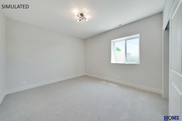 unfurnished room featuring visible vents, light colored carpet, and baseboards