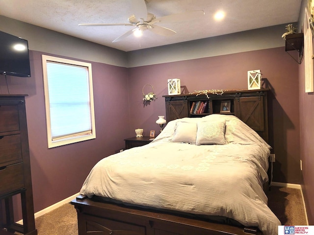 carpeted bedroom featuring baseboards and ceiling fan