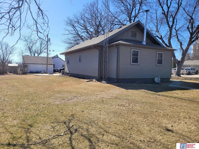 view of side of property with a lawn