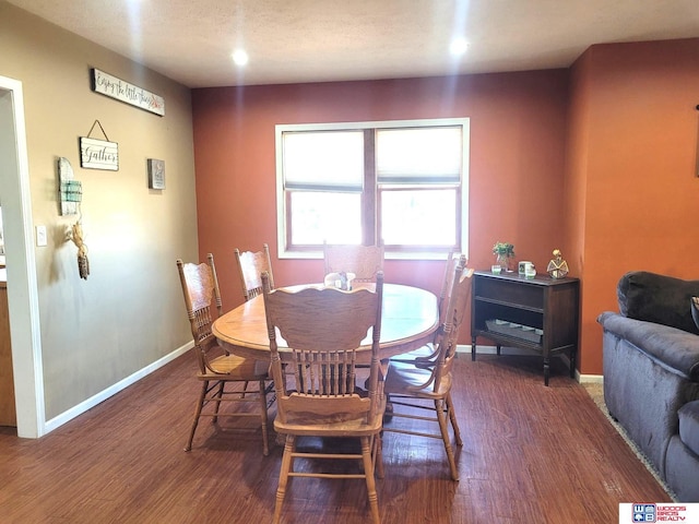 dining area featuring baseboards and wood finished floors