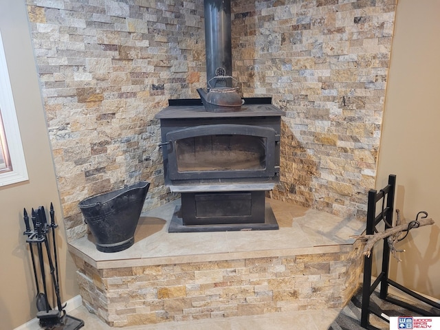 room details featuring baseboards and a wood stove