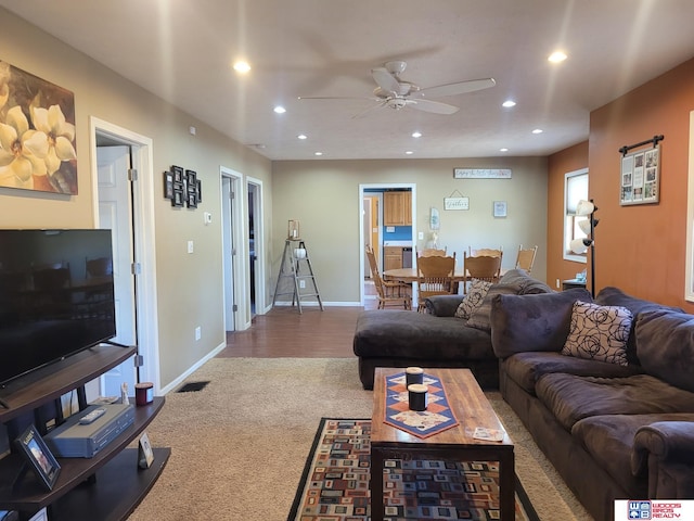 living area featuring recessed lighting, baseboards, and carpet floors