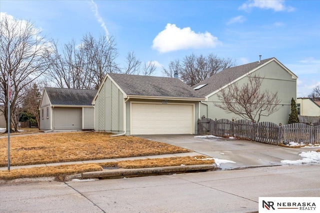 view of property exterior with fence, a garage, driveway, and roof with shingles