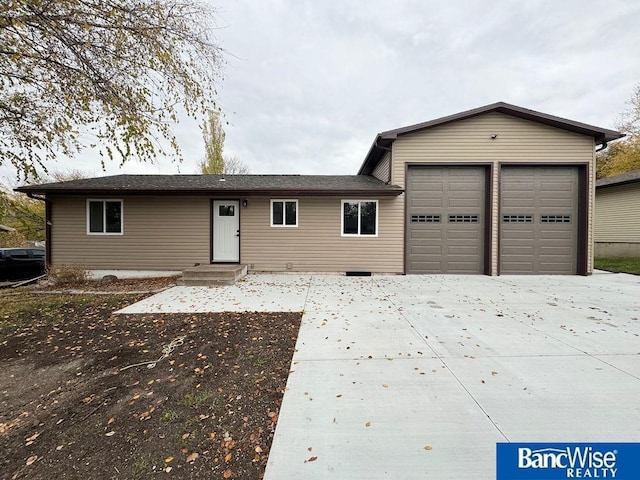 ranch-style home featuring entry steps and a garage