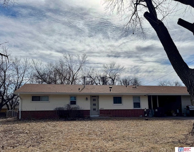 ranch-style house featuring brick siding and an attached garage