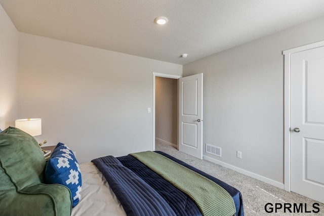 carpeted bedroom featuring baseboards and visible vents