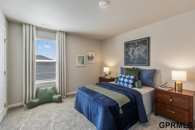 carpeted bedroom with visible vents and baseboards