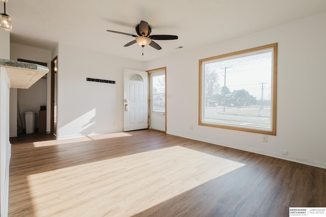 entrance foyer with ceiling fan, visible vents, baseboards, and wood finished floors