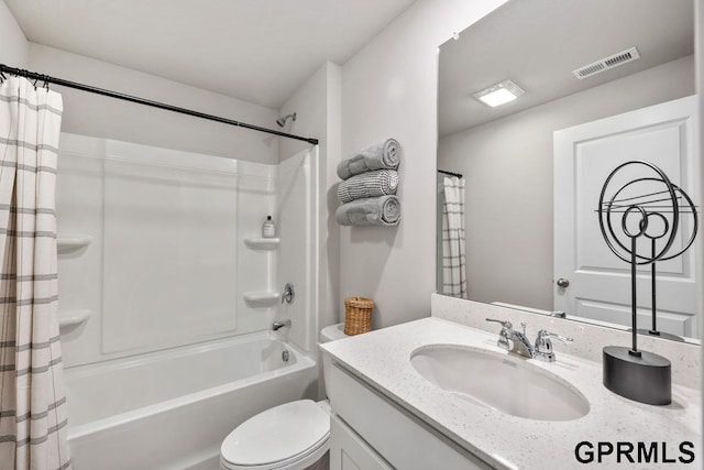 bathroom featuring visible vents, vanity, shower / tub combo, and toilet