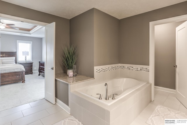 ensuite bathroom featuring tile patterned floors, a bath, ensuite bathroom, and ceiling fan