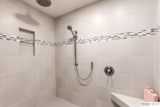 full bath with a tile shower